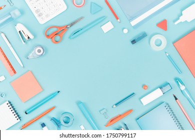 Assorted office and school white orange and blue stationery supply on pastel trendy background as knolling. Flat lay with copy space for back to school or education and craft concept.