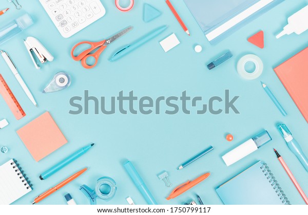 Assorted office\
and school white orange and blue stationery supply on pastel trendy\
background as knolling. Flat lay with copy space for back to school\
or education and craft\
concept.