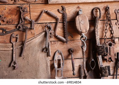 Assorted old work tools on wooden wall