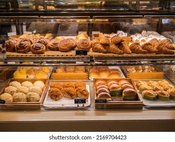 Assorted pastry and bread arranged on tray selling at bakery shop. - Shutterstock ID 2169704423