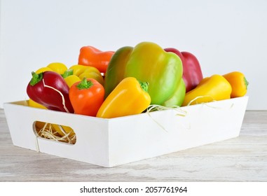 Assorted Peppers In A White Wooden Box, Light-colored Base And Bottom.