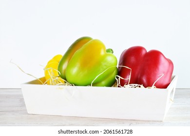 Assorted Peppers In A White Wooden Box, Light-colored Base And Bottom.