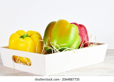 Assorted Peppers In A White Wooden Box, Light-colored Base And Bottom.