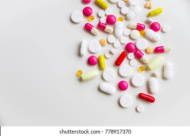 Assorted pharmaceutical medicine pills, tablets and capsules.Pills background. Heap of assorted various medicine tablets and pills different colors on white background. Health care.Top view.Copy space - Shutterstock ID 778917370