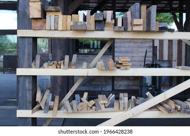 Assorted Pieces Of Scrap Wood Placed On Tiered Shelf, In Wood Shop