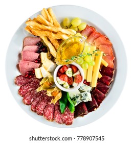 Assorted plate with meat, bread, cheese, grapes, chile and sause. Top view, flat lay