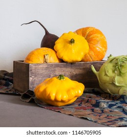 Assorted pumpkins and squashes on rustic wooden boards with an shinning autumn backdrop