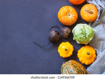 Assorted pumpkins and squashes on rustic wooden boards with an shinning autumn backdrop