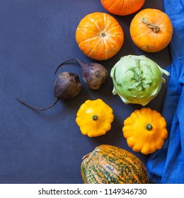 Assorted pumpkins and squashes on rustic wooden boards with an shinning autumn backdrop