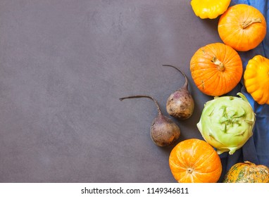 Assorted pumpkins and squashes on rustic wooden boards with an shinning autumn backdrop