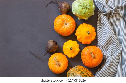 Assorted pumpkins and squashes on rustic wooden boards with an shinning autumn backdrop