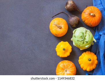 Assorted pumpkins and squashes on rustic wooden boards with an shinning autumn backdrop
