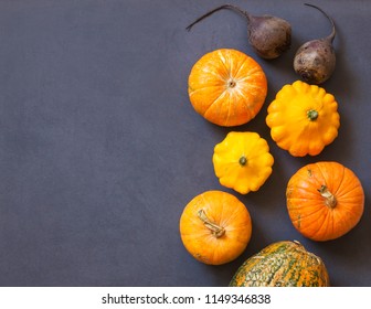 Assorted pumpkins and squashes on rustic wooden boards with an shinning autumn backdrop