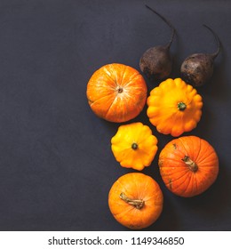Assorted pumpkins and squashes on rustic wooden boards with an shinning autumn backdrop
