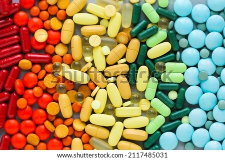 Assorted rainbow colorful tablets, pills, drugs background. Medication and healthcare concept. Close up, top view