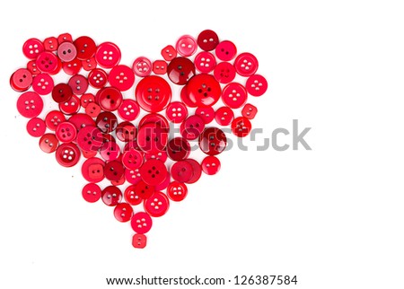 Assorted red buttons in shape of heart on white background