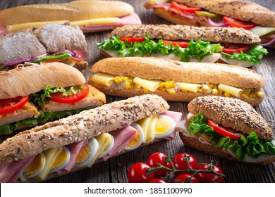 Assorted Sandwiches On Wooden Background.