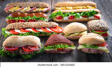 Assorted Sandwiches On Wooden Background.