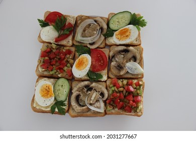 Assorted Sandwiches. Toast With Mushrooms, Egg, Cucumber, Tomatoes, Zucchini And Onion. 9 Pieces