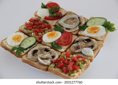 Assorted Sandwiches. Toast With Mushrooms, Egg, Cucumber, Tomatoes, Zucchini And Onion. 9 Pieces