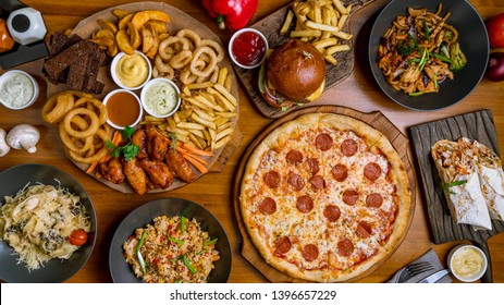 Assorted set from pizza Pepperoni, Assorted beer snacks, burger, wok and rice top view - Powered by Shutterstock