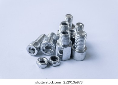 Assorted Silver Hex Socket Cap Screws and Nut on White Background
 