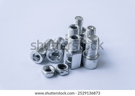 Assorted Silver Hex Socket Cap Screws and Nut on White Background
 