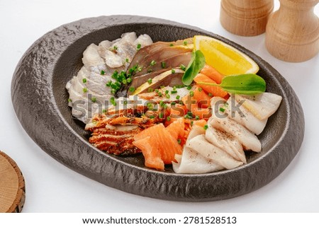Assorted sliced fish appetizer platter with lemon