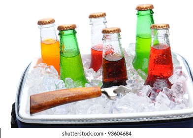 Assorted Soda Bottles In A Cooler Full Of Ice With Bottle Opener. Horizontal Format Over White.