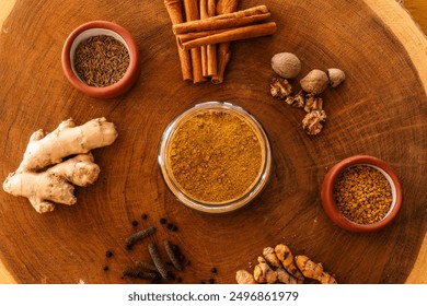 Assorted Spices and Herbs on Rustic Wooden Surfaces A top-down image showcasing a variety of spices and herbs, including cinnamon sticks, ginger root, turmeric root, nutmeg, fenugreek seeds, cumin. - Powered by Shutterstock