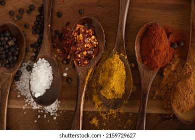 Assorted spices on a wooden choppingboard