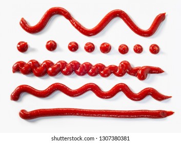 Assorted squiggles, wavy lines and dots of tomato sauce dispensed from a tube isolated on white as food design elements