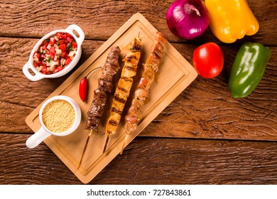 Assorted Steak Skewers On Top Of A Board