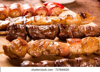 Assorted Steak Skewers On Top Of A Board