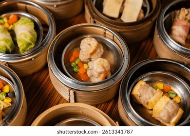Assorted steamed dim sum with leaf garnish in traditional steamers.