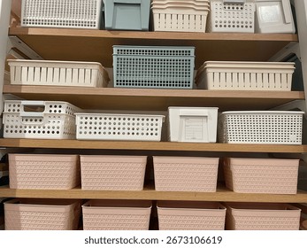 Assorted Storage Baskets in White, Blue, and Pink on Wooden Shelves