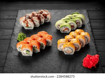 Assorted sushi nigiri and maki big set on slate. A variety of Japanese sushi with tuna, crab, salmon, eel and rolls. Top view. Asian cuisine. Photo for the menu. - Powered by Shutterstock