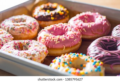 Assorted Sweet Donuts In A Paper Box.