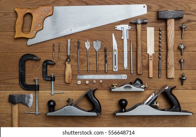 assorted tools for carpenter on wood background - Shutterstock ID 556648714