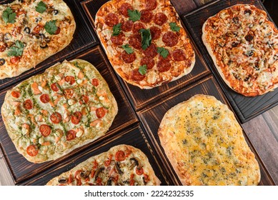 Assorted traditional rome pizza. Roman square pizza. Mix Pinsa on a thick dough, Italian Cuisine.Top view. - Powered by Shutterstock