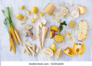 Assorted Types Of Yellow Hued Fruits And Vegetables Shot Overhead, Carrot Corn Lemon Pineapple Pear Parsnip Bell Pepper Capsicum Golden Beetroot, Part Of A Color Spectrum Collection