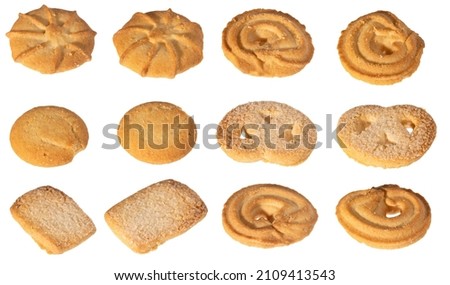 Assorted various forms of danish crumbly cookies isolated on white. Shooting angle 45 degrees, harsh light from the left. 