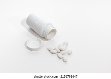 Assorted white pharmaceutical capsules, pills, tablets, and medication 