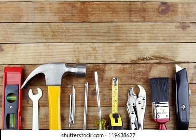 Assorted work tools on wood - Shutterstock ID 119638627