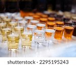 Assortiment of Strong alcoholic drinks, hard liquors, spirits and distillates in glasses: vodka, cognac, whiskey and other. Hard light copy space. Alcohol concept