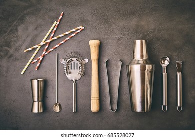 An Assortment Of Alcoholic Beverage Utensils, Including A Martini Cocktail Shaker, Isolated On A Rustic Grey Concrete Background.