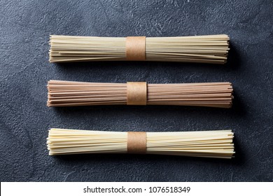 Assortment Of Asian Soba, Green Tea And Egg Noodles. Slate Background. Top View.