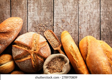 Assortment of baked bread on wooden table background - Shutterstock ID 278970809
