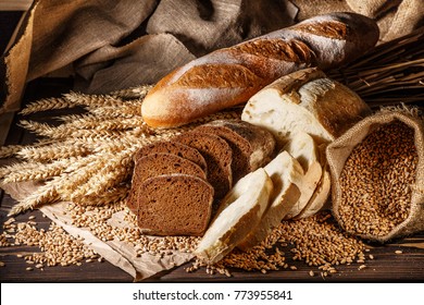 Assortment of baked bread on wooden table background - Powered by Shutterstock