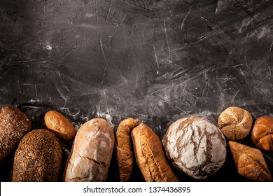 Assortment of baked goods on dark table with free copy space for text. Top view, from above, flat lay.